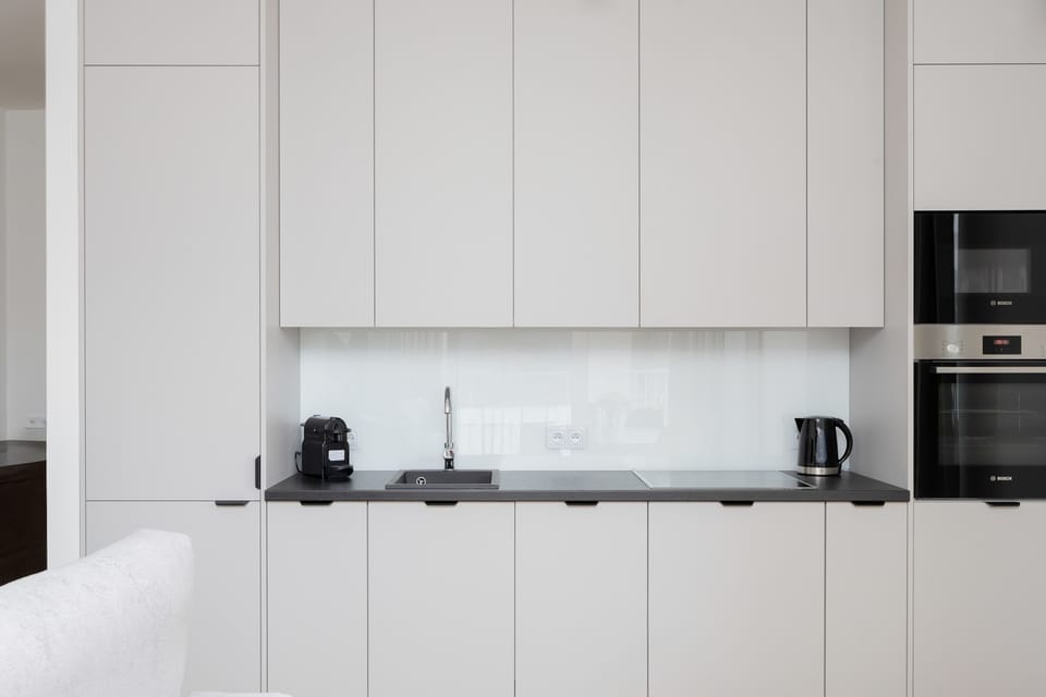 Kitchenette with oven and refrigerator. 