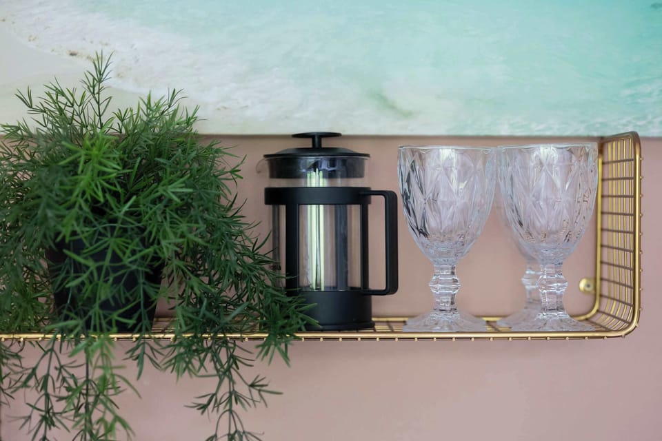 Close-up of wine glasses and coffee brewer.