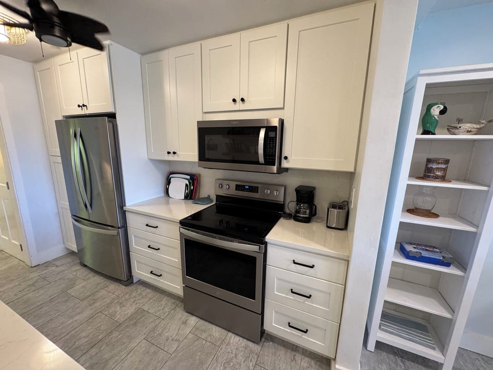 appliances include electric stove, microwave, refrigerator and dishwasher