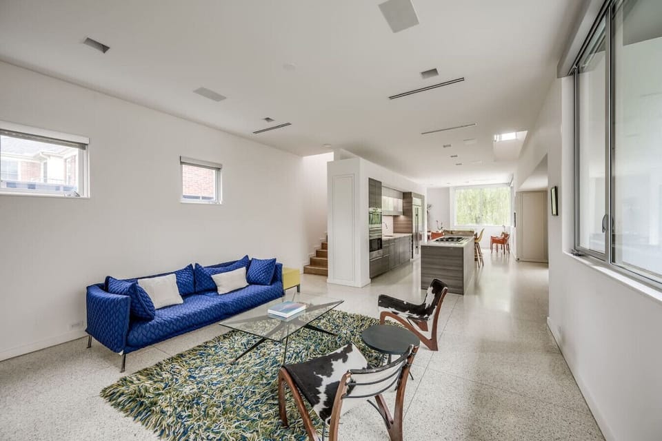 The living room downstairs is connected to the kitchen & has a very comfortable Minotti couch and comfy seating.