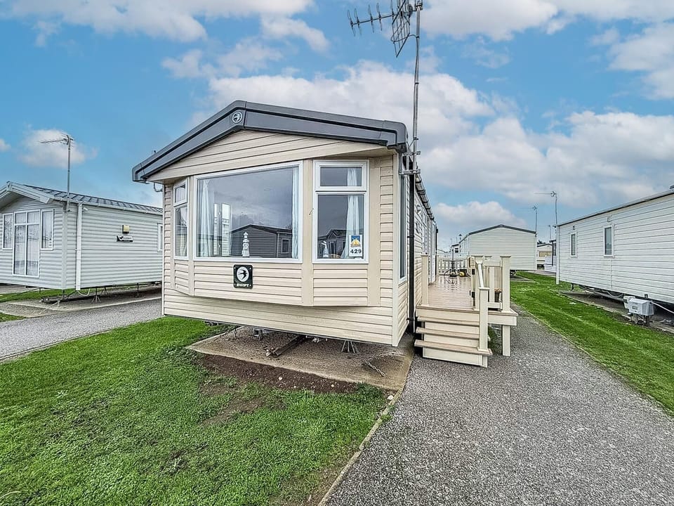 Cozy mobile home with bright windows and outdoor seating area