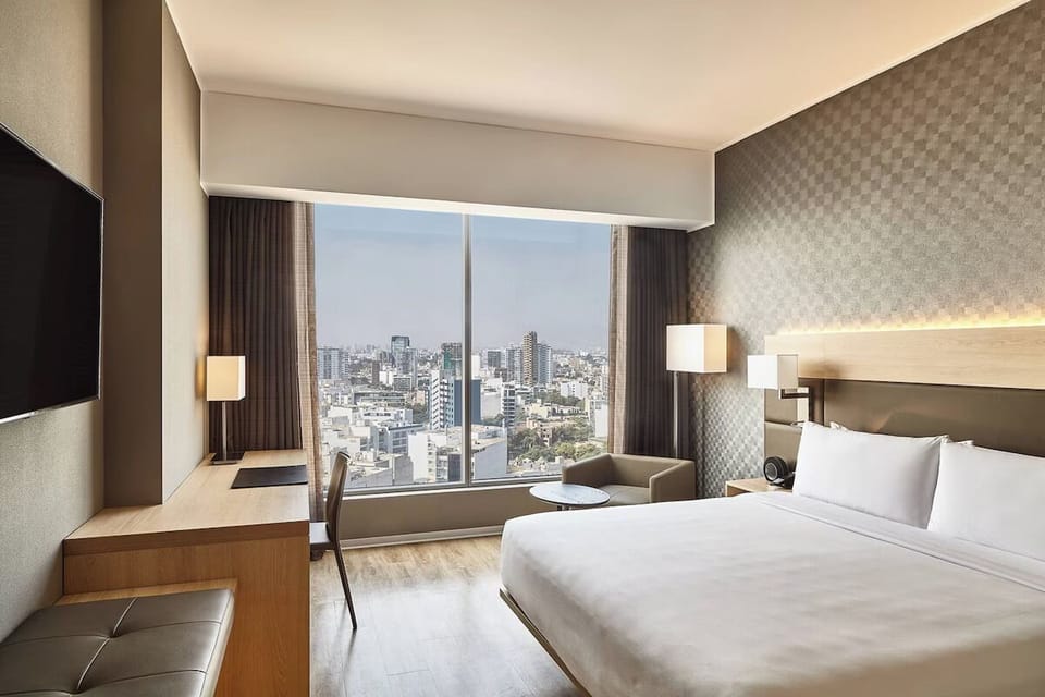 Wake up to bright skyline views from your plush bed.