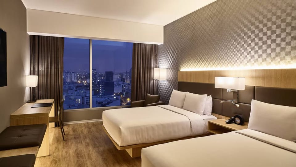 Enjoy a cozy night’s sleep with the skyline glowing beyond.