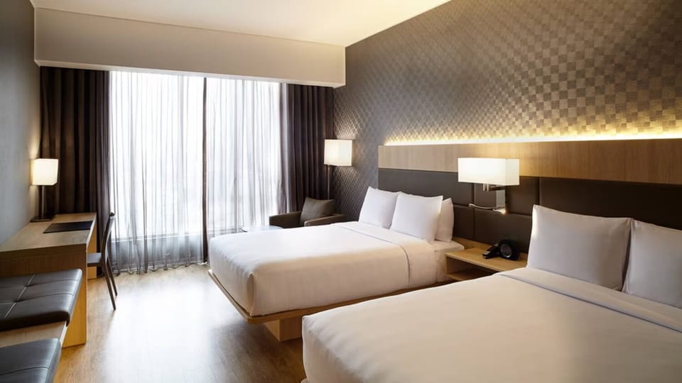 Unwind in bright twin room with sleek modern comforts.