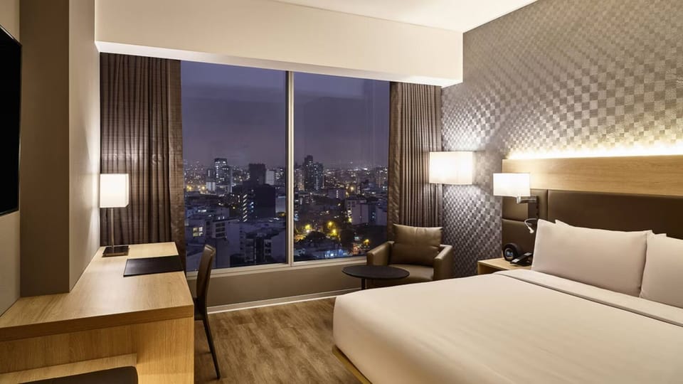 Wake up to sweeping city views from your king bed.