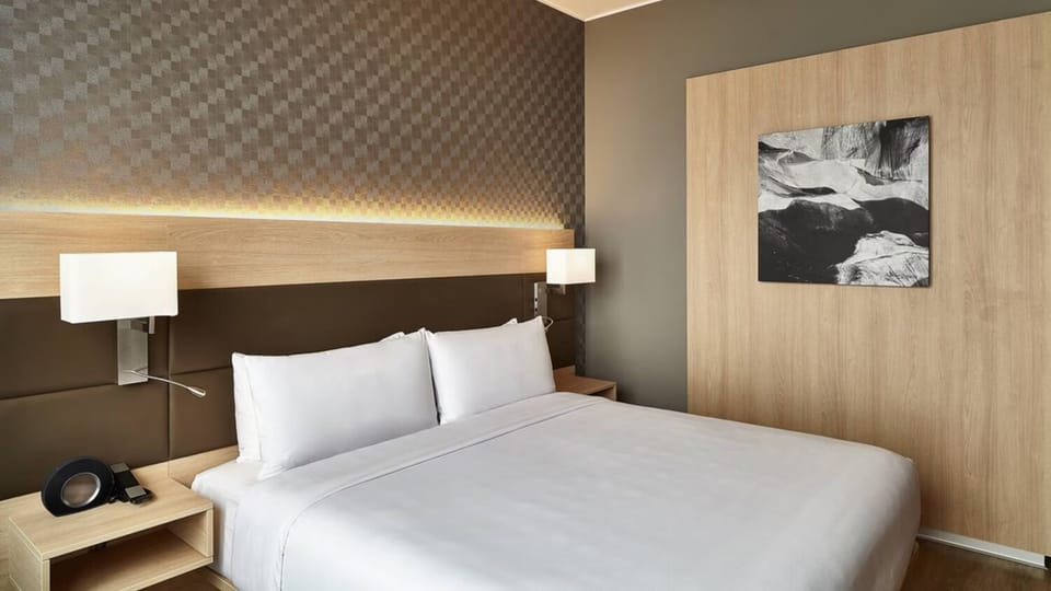 Relax at dusk as the skyline glows beyond tall windows.