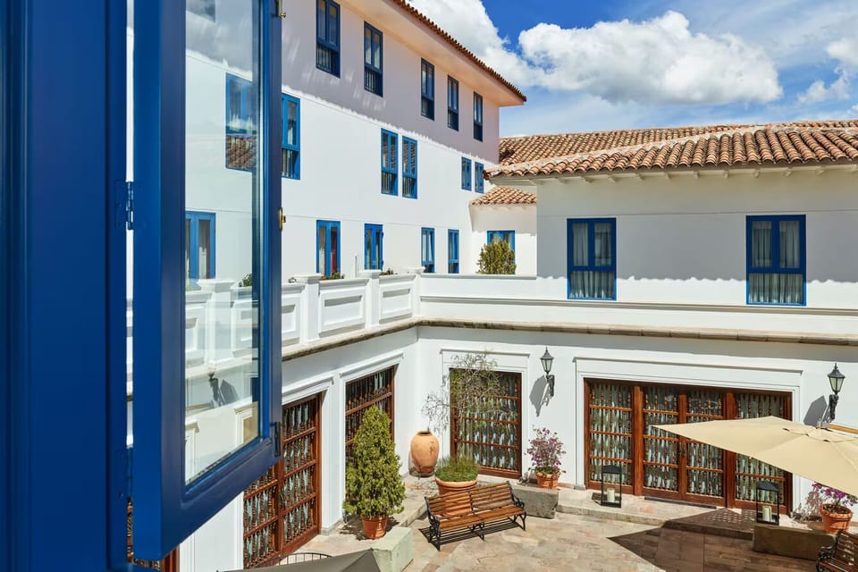 Breathe in sunlit courtyard charm framed by classic white walls.