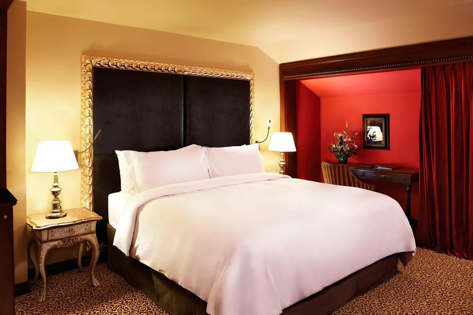 Unwind in a serene bedscape with glowing bedside lamps.