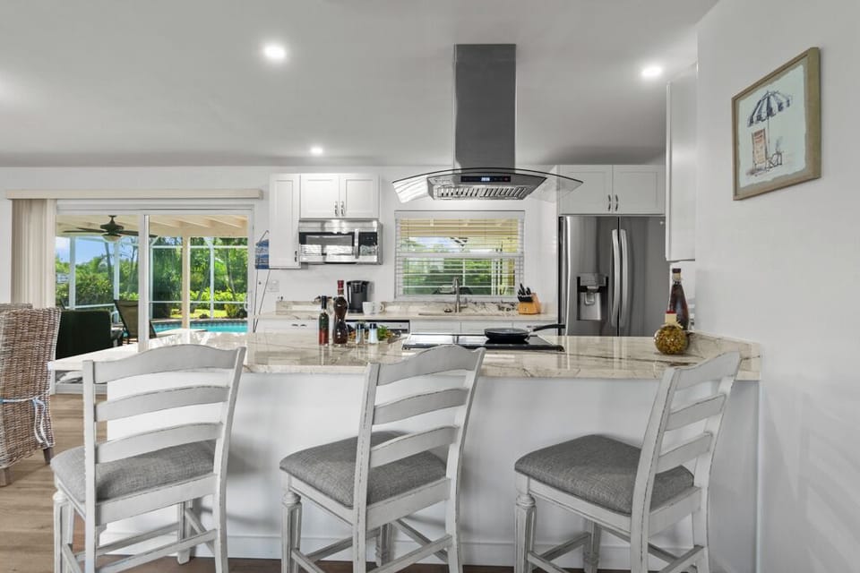Newly renovated kitchen with granite countertops and modern appliances—designed for gathering