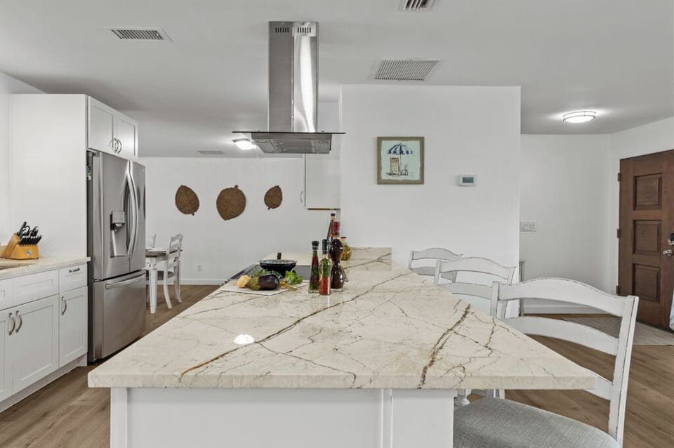 Newly renovated kitchen with granite countertops and modern appliances—designed for gathering