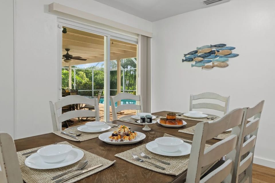 Dining area with sliding doors opening to the lanai for seamless indoor-outdoor living