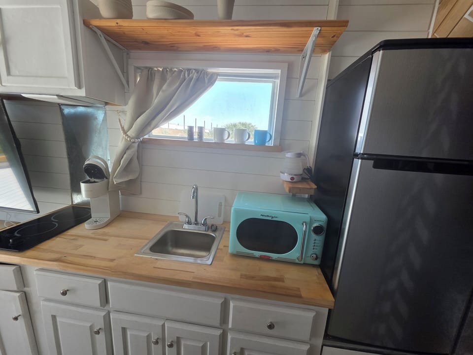 Kitchenette with 2 burner electric cooktop, microwave, fridge, Keurig and tea kettle