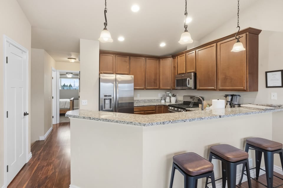 Large kitchen sits at the top of the stairs to center the open plan of the house