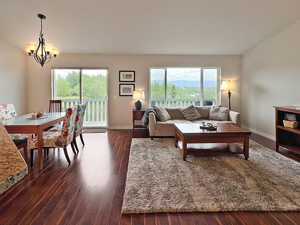 Open floor plan takes advantage of large windows to bring outdoors in.