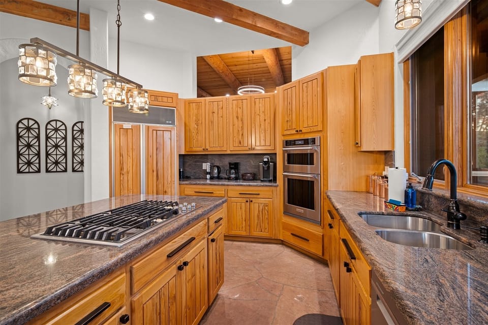 Fully-equipped kitchen with stainless appliances, Keurig, and espresso machine