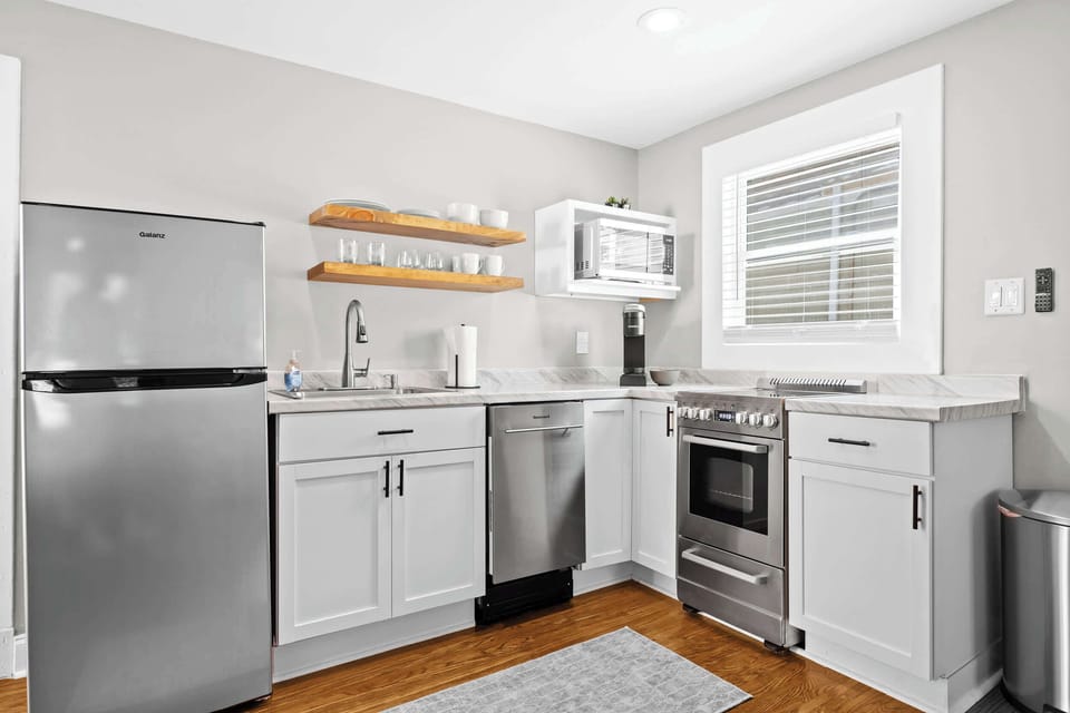 Kitchen: Whip up your favorite meals in this fully equipped kitchen — where modern amenities meet homey charm for a seamless cooking experience.