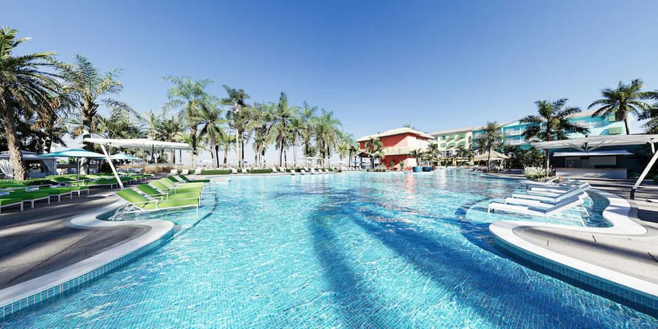 Dive into a sprawling resort pool with shaded cabanas.