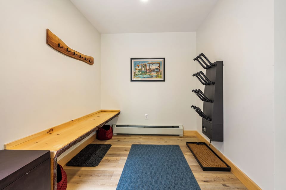 The entryway includes an extra long bench and a 12-port boot dryer