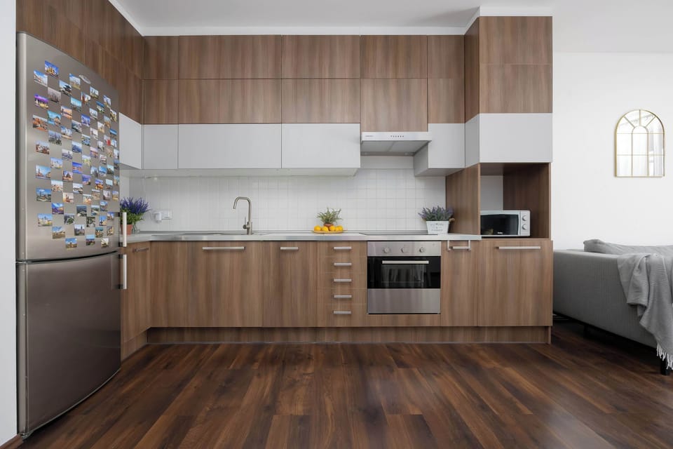 Kitchenette with oven and refrigerator. 