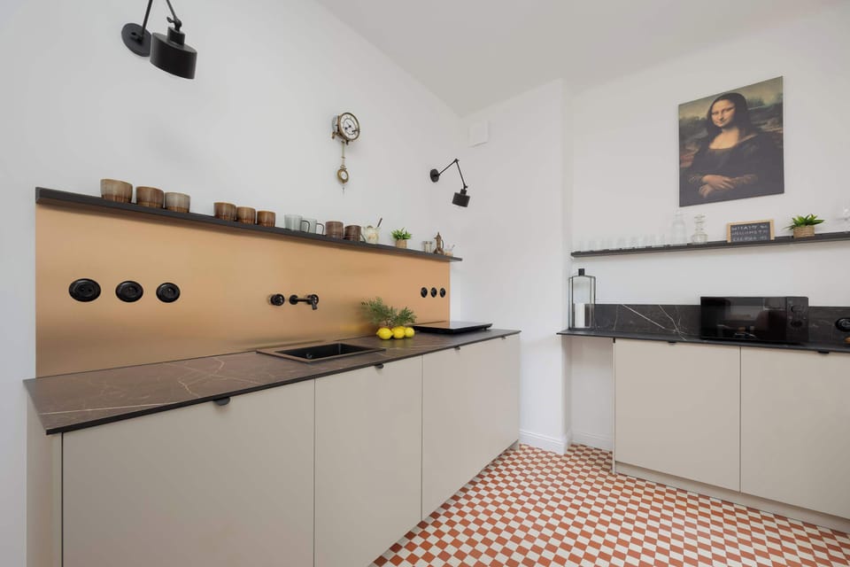 A wider view of the kitchen with clean lines and minimalist storage, showcasing a functional layout.