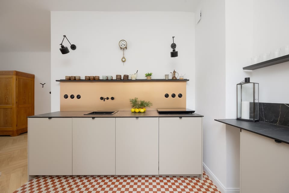 A kitchen space from a slightly different angle, emphasizing the countertop workspace and minimal decor.