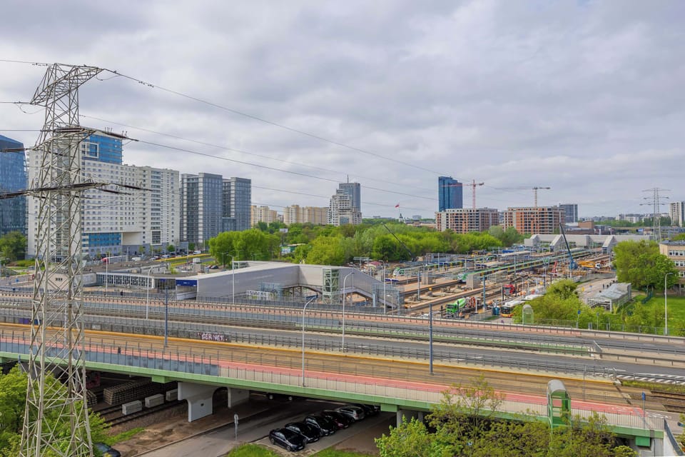 The windows open to a vibrant city view with convenient access to public transport.