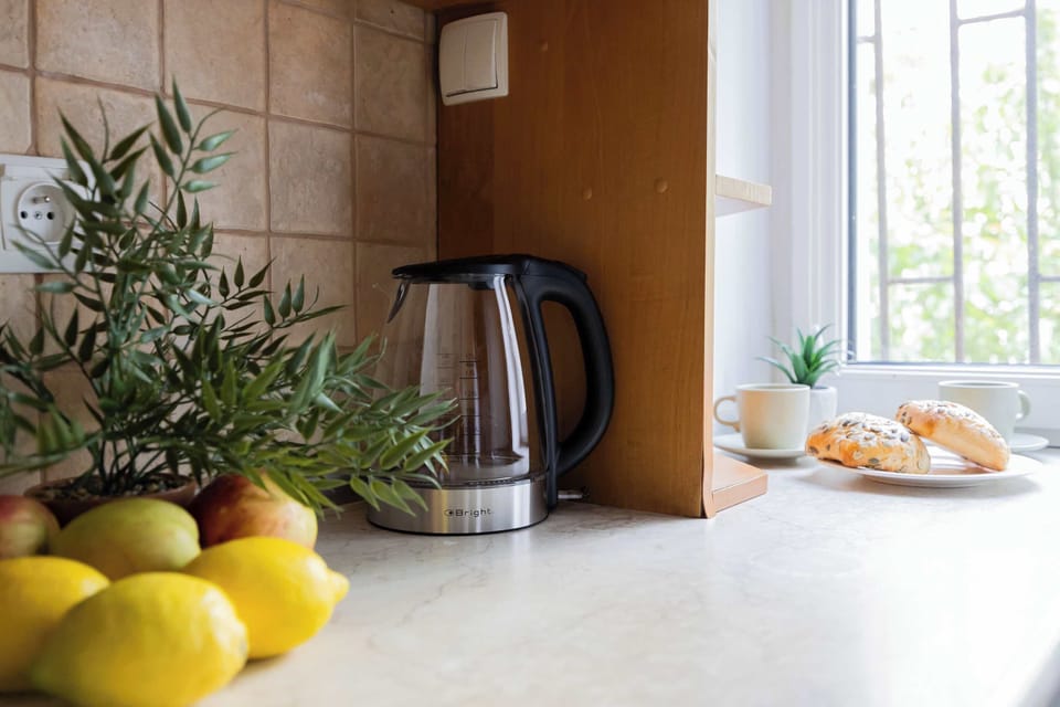 A coffee corner with a kettle and green view makes mornings more enjoyable.