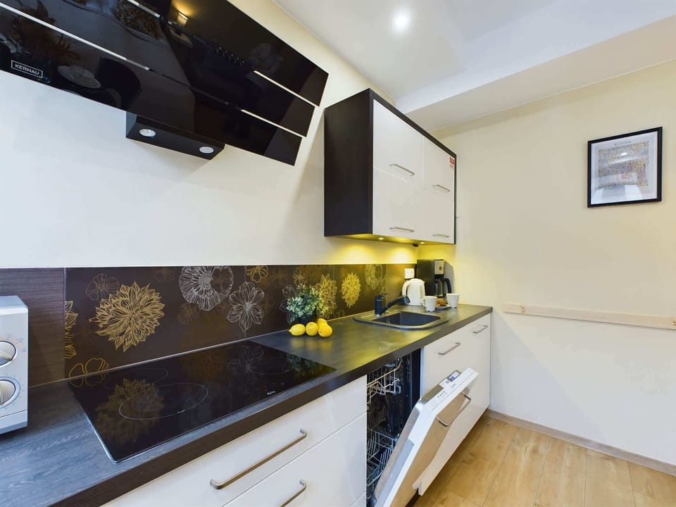 The modern kitchen with white cabinets that have all the necessary accessories, also has high-quality appliances,