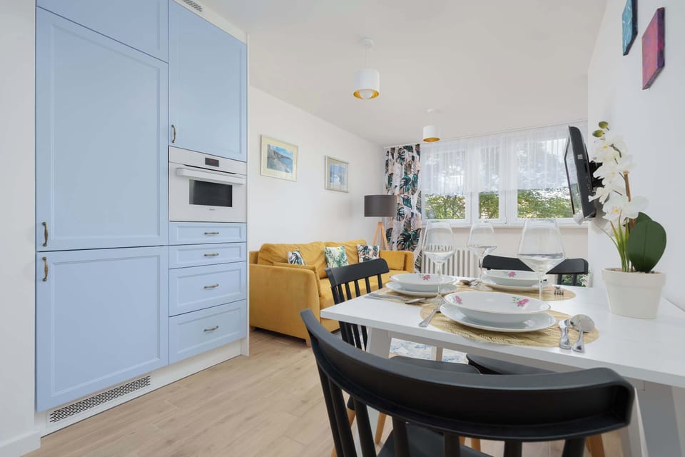 A bright kitchen with a window and breakfast table offers a functional spot to start the day.