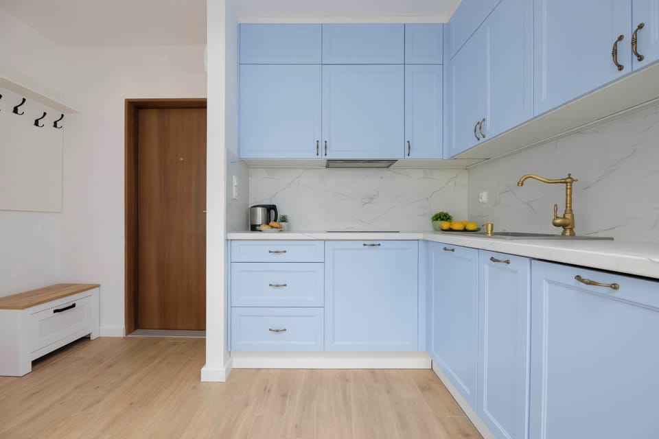 An entryway with cabinets and hooks helps keep things tidy from the moment you walk in.