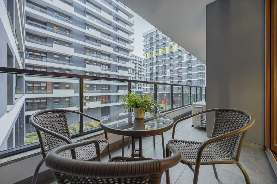 The furnished balcony offers a perfect spot for morning coffee with a view.