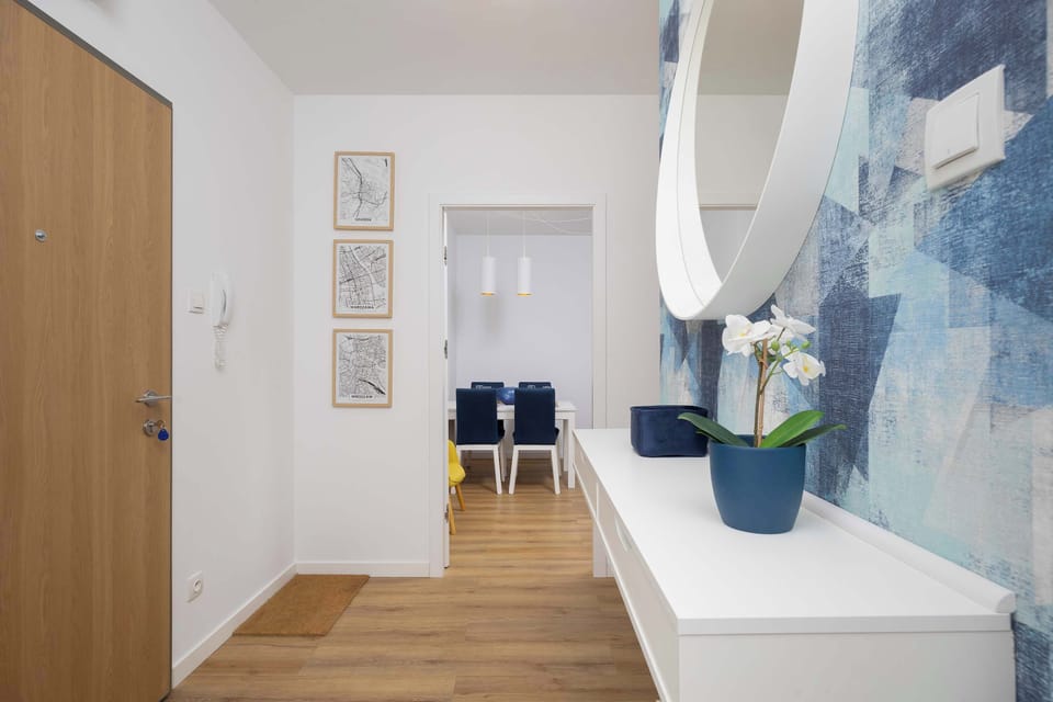 The apartment featuring a stylish mirror that adds depth to the space.