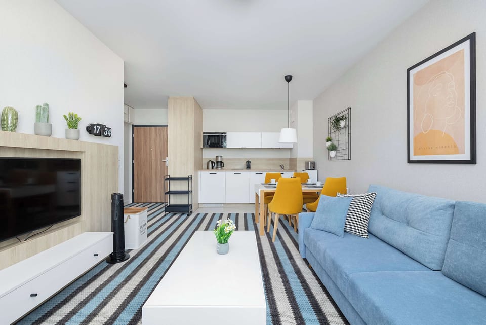 Living room with table, chairs and sofa.