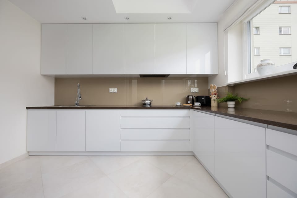A bright, well-lit kitchen with a large window makes cooking with a view a pleasure.