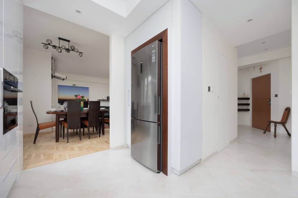 A bright hallway with elegant tiles leads directly to the spacious dining area.