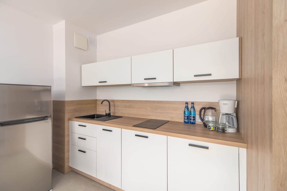 Kitchenette with a fridge.