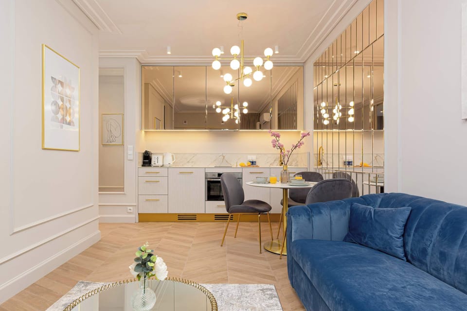 Unique living room with a comfortable sofa bed and elegant kitchenette with dining area.