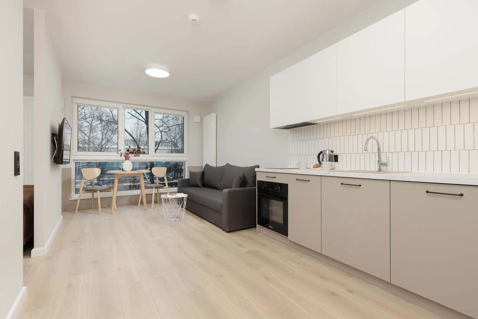 Fully equipped kitchenette with dining table and chairs.