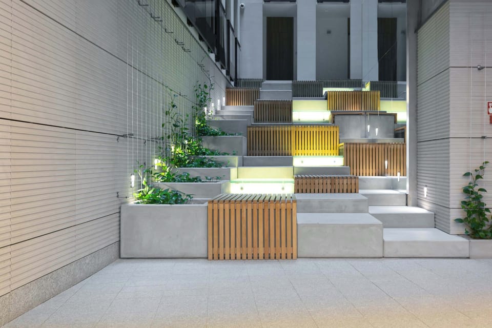 Steps leading to the building entrance, surrounded by minimal landscaping.