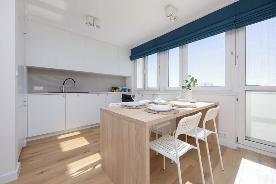 A wooden dining table and kitchenette will allow you to prepare and eat meals together.