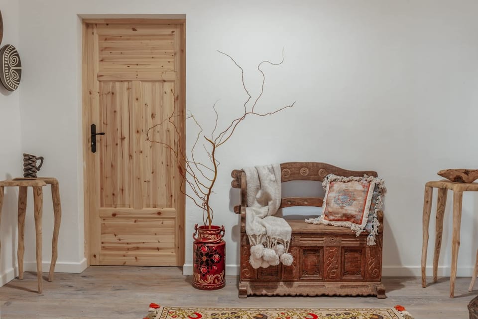 A rustic-style living area with exposed brick walls, wooden beams, and vintage furnishings, creating a cozy and warm atmosphere.