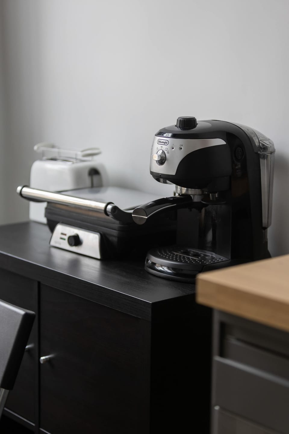 Coffee maker and toaster in the kitchen.