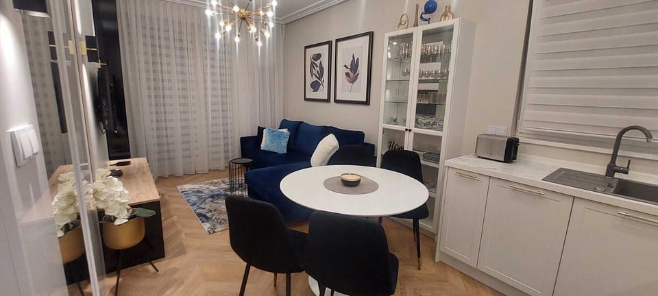 An elegant living room with large windows letting in plenty of natural light creates a bright and welcoming atmosphere.