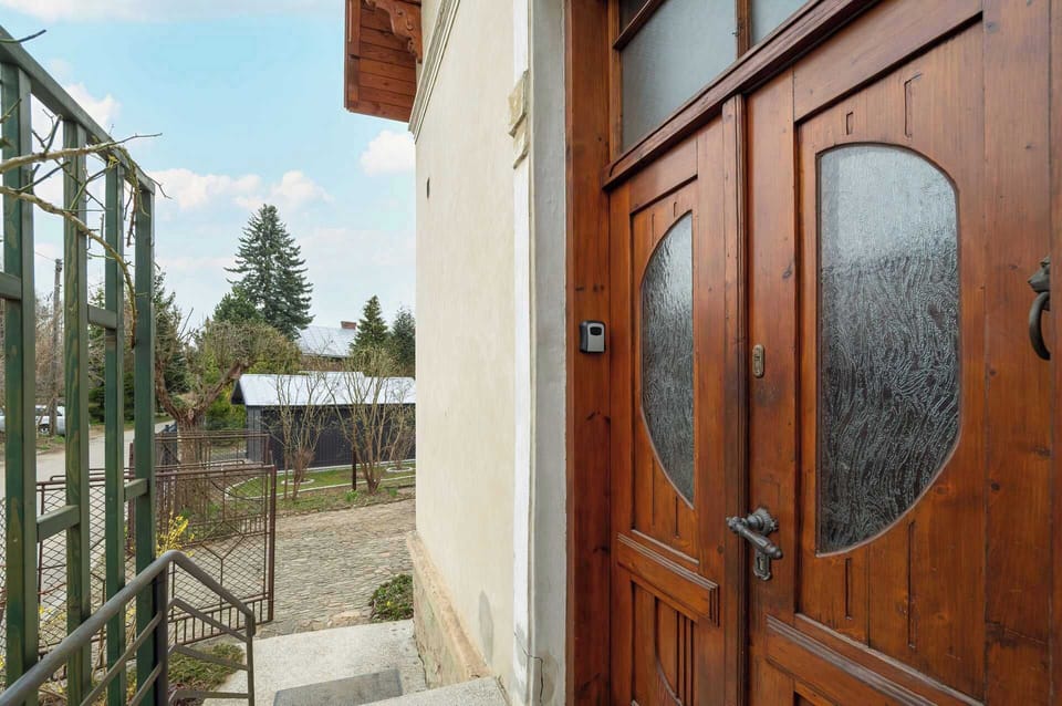 A large, solid wooden door invites you into the apartment.