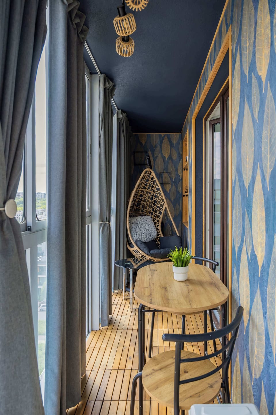 A charming, enclosed balcony with patterned walls, small table and chairs, perfect for morning coffee or relaxing evenings.