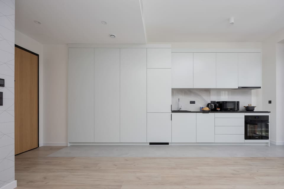 Minimalist cabinetry with ample storage makes it easy to keep the kitchen tidy.