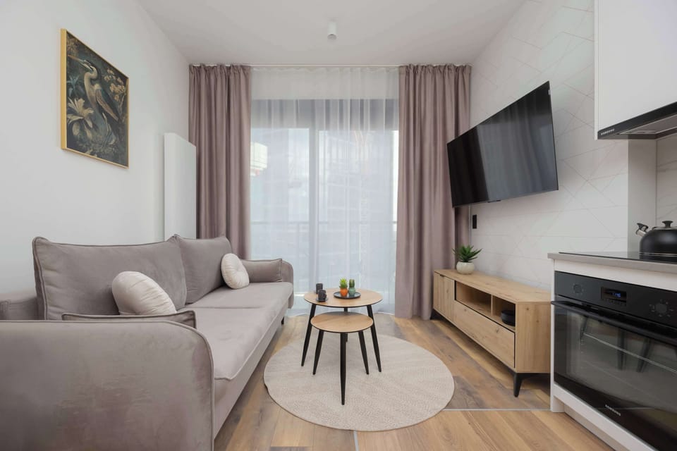 A cozy living room with a balcony window and blinds ensures privacy and warmth.