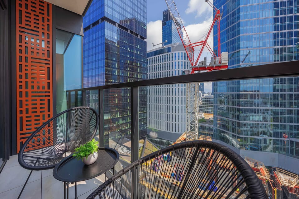 The balcony with city views and a coffee nook is ideal for a peaceful morning moment.