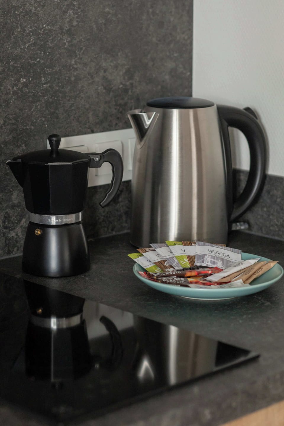 A close-up shot of a coffee maker and kettle on a kitchen countertop, emphasizing the convenience and amenities provided for guests.