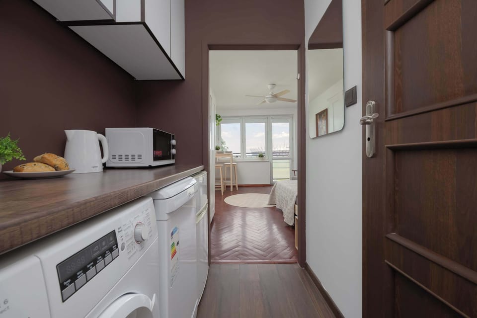 Fully equipped kitchenette with electric hob, microwave, refrigerator, freezer, electric kettle, dishwasher and washing machine.